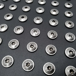 Pan head bolts arranged in a grid on a metal background. 