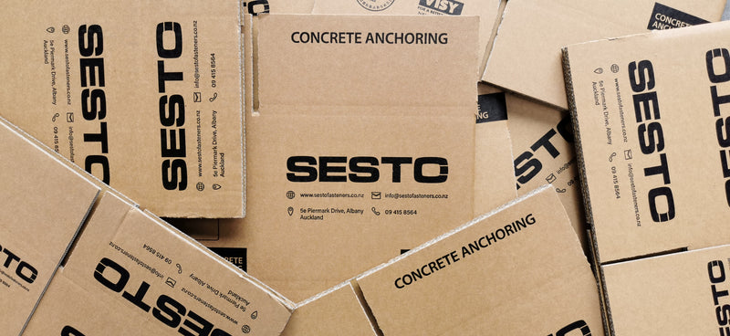 Sesto Fasteners Eco Packaging boxes arranged in a pile.