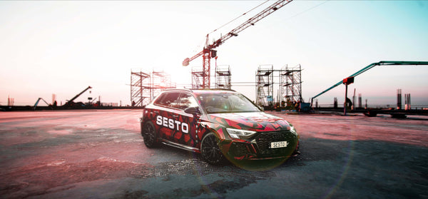 Audi with Sesto Fasteners decals and wrap in a construction site.