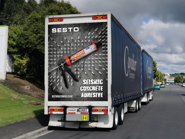 Sesto Fasteners Truck Ad with fasteners arranged around adhesive.